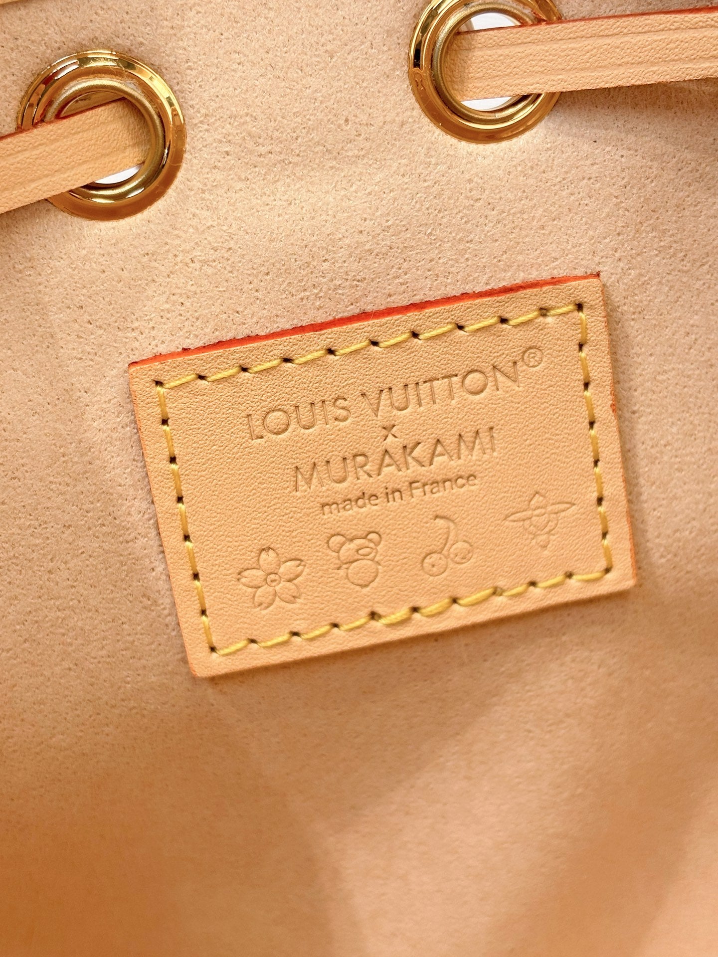 Louis Vuitton bag close-up leather label with “Made in France” and floral detail