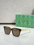 Gucci sunglasses with dark tortoiseshell-style frames and brown-tinted lenses