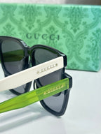 Gucci sunglasses side detail with navy frame and green accent arm