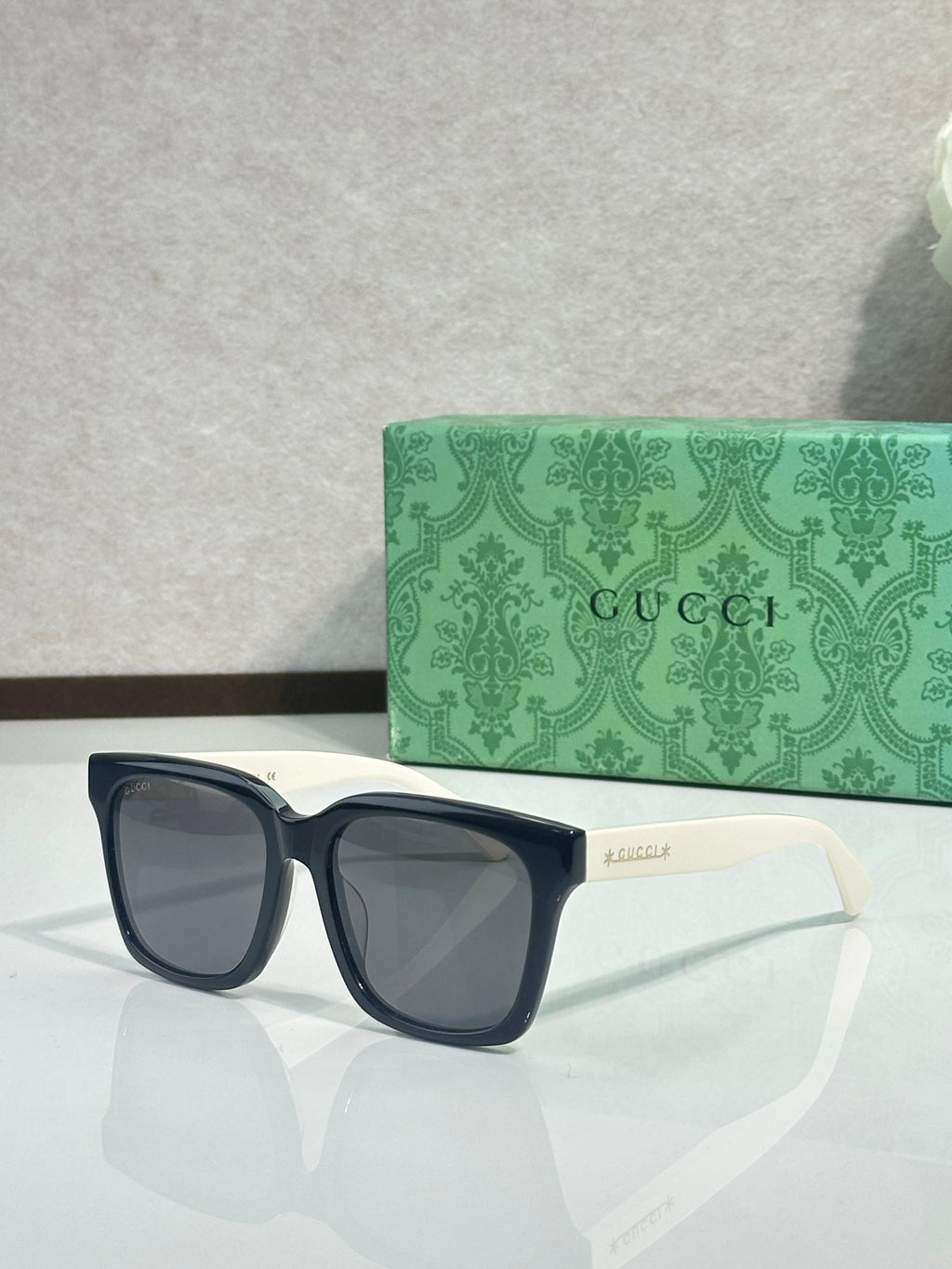 Gucci sunglasses with dark frames and smoke lenses