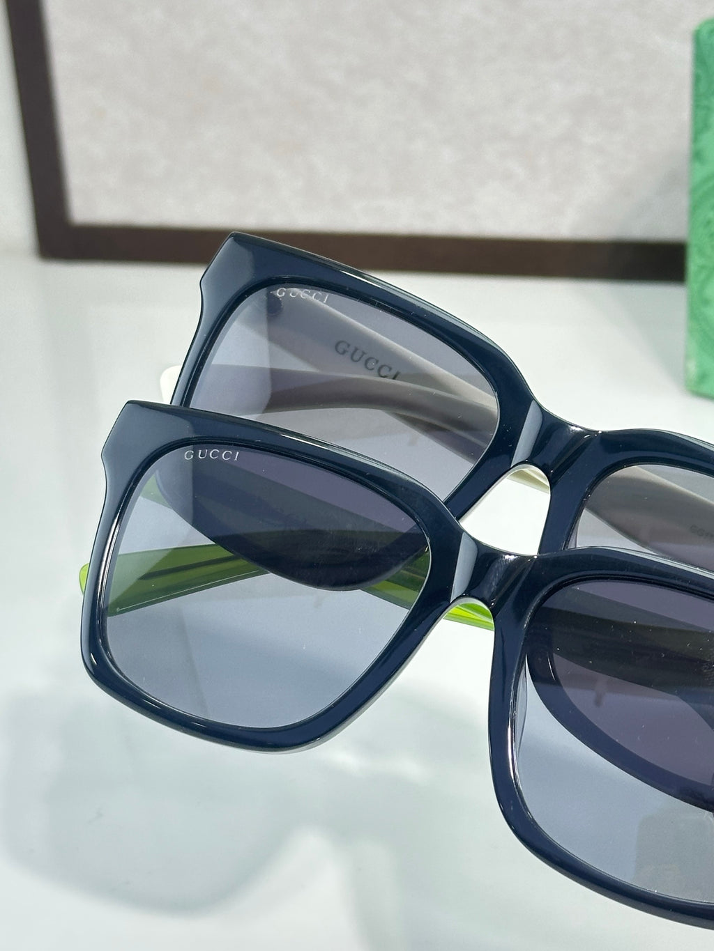 Gucci sunglasses close-up with navy frames and dark lenses