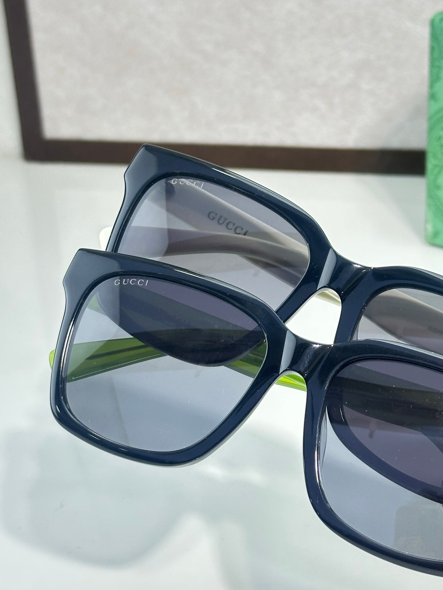 Gucci sunglasses close-up with navy frames and dark lenses
