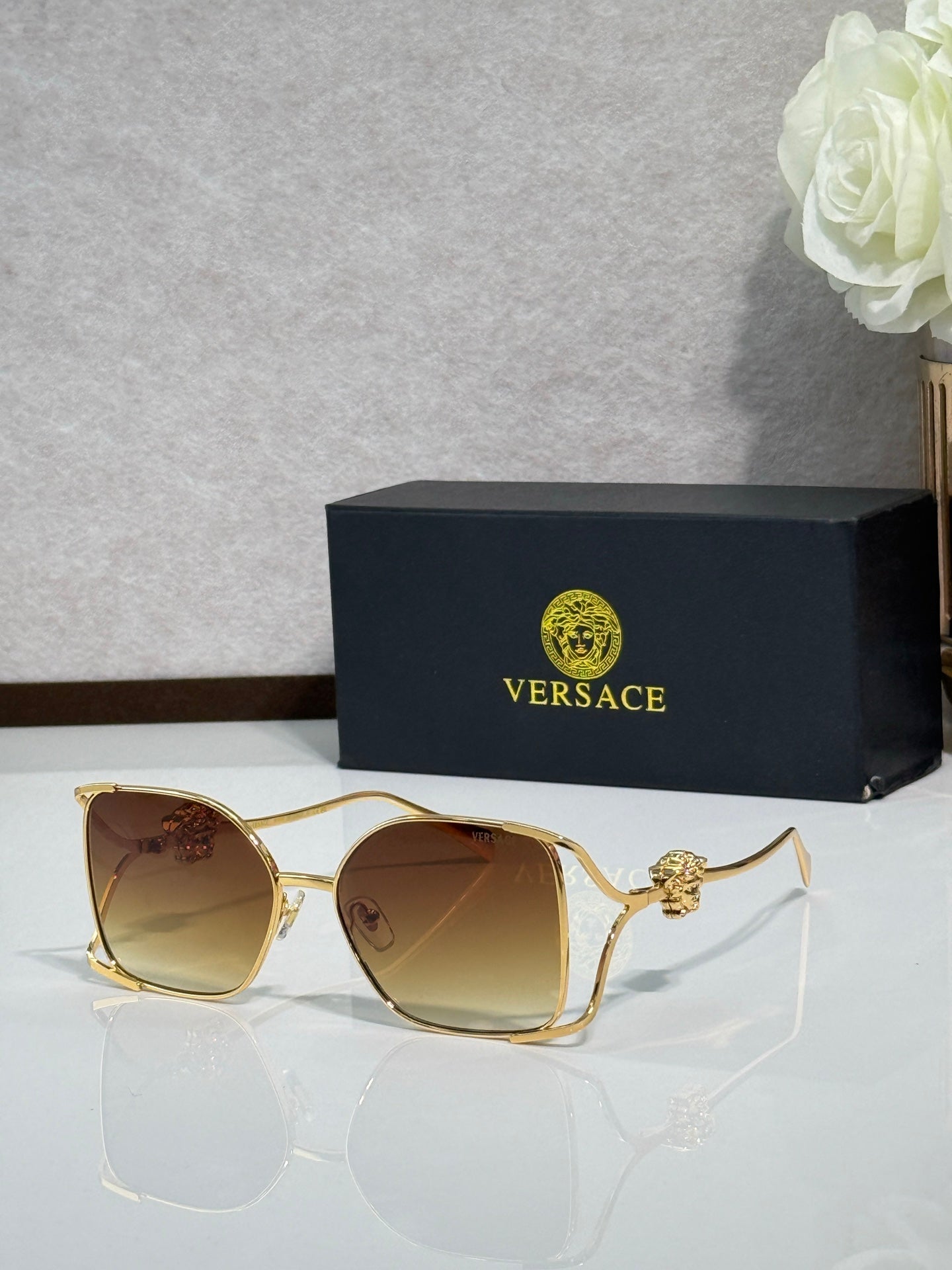 Versace sunglasses with gold metal frame and brown tinted lenses