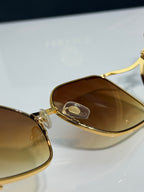 Versace sunglasses close-up, gold frame with amber tinted lenses