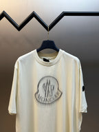 Cream short-sleeve T-shirt with front crest logo graphic and crew neckline