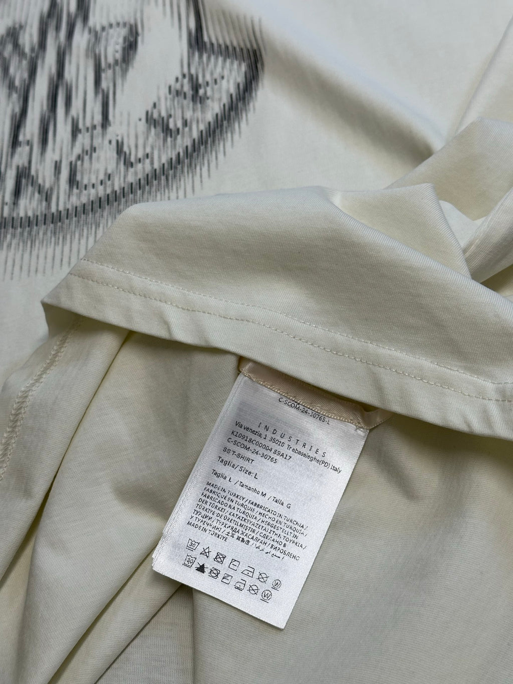 Cream T-shirt with white care label inside neckline