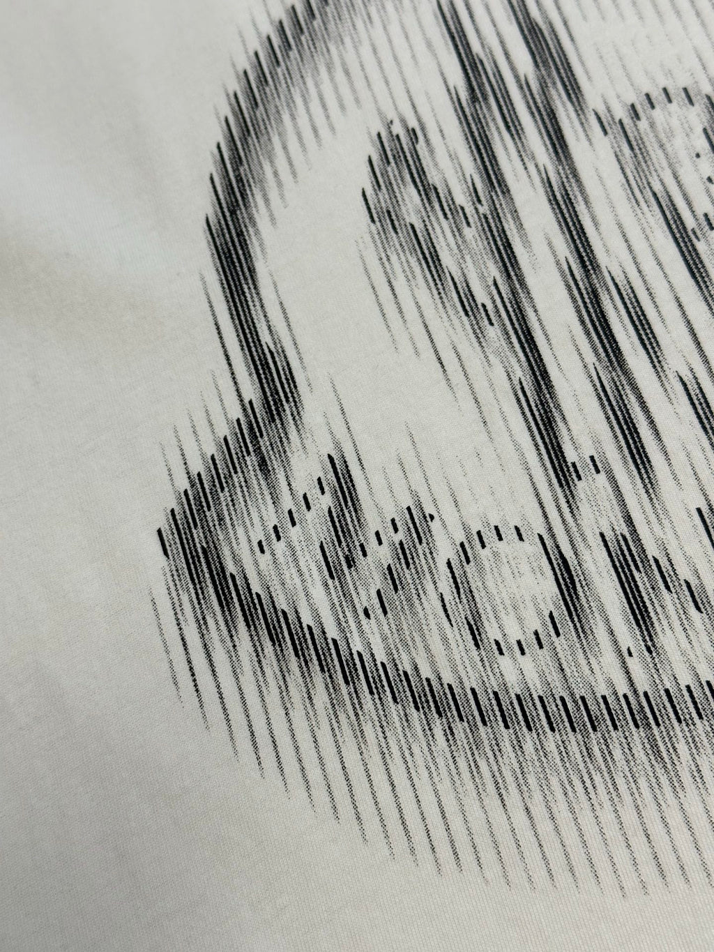 Cream T-shirt crest graphic in black halftone print