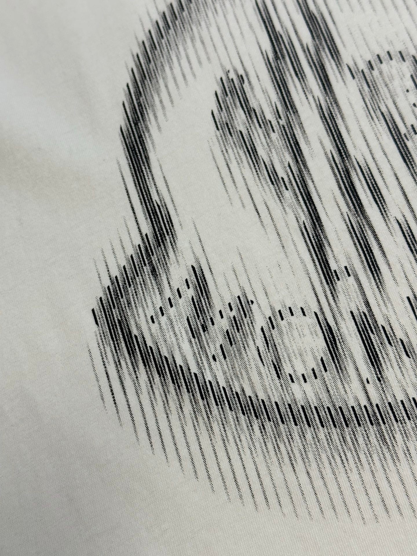 Cream T-shirt crest graphic in black halftone print