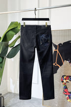 Dark denim jeans with embroidered logo graphic panel on front pocket