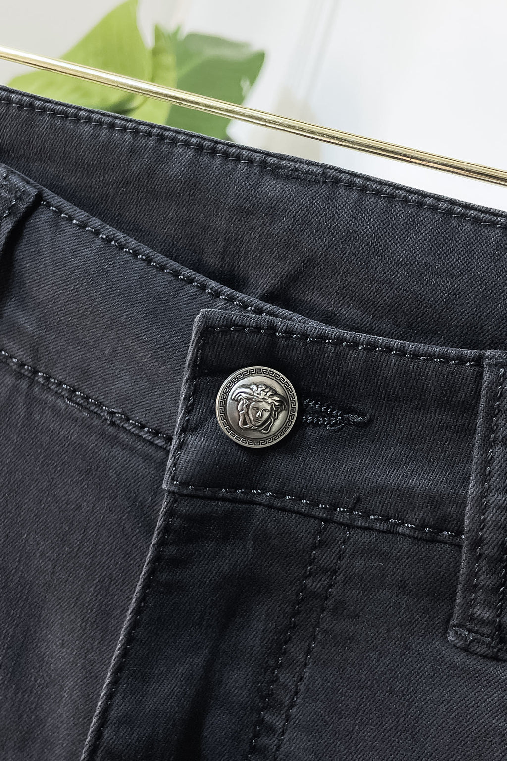 Dark denim jeans coin pocket with round engraved logo button