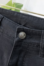 Dark denim jeans coin pocket with round engraved logo button