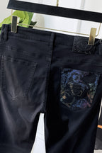 Dark denim jeans with embossed logo patch and embroidered pocket graphic