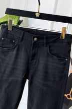 Dark denim jeans waistband and front pockets with metal button details
