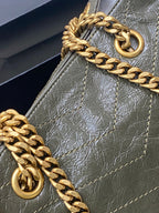Gold chain handle and ring hardware on dark green pebbled leather tote