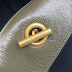 Gold Saint Laurent logo push-lock on dark green pebbled leather bag