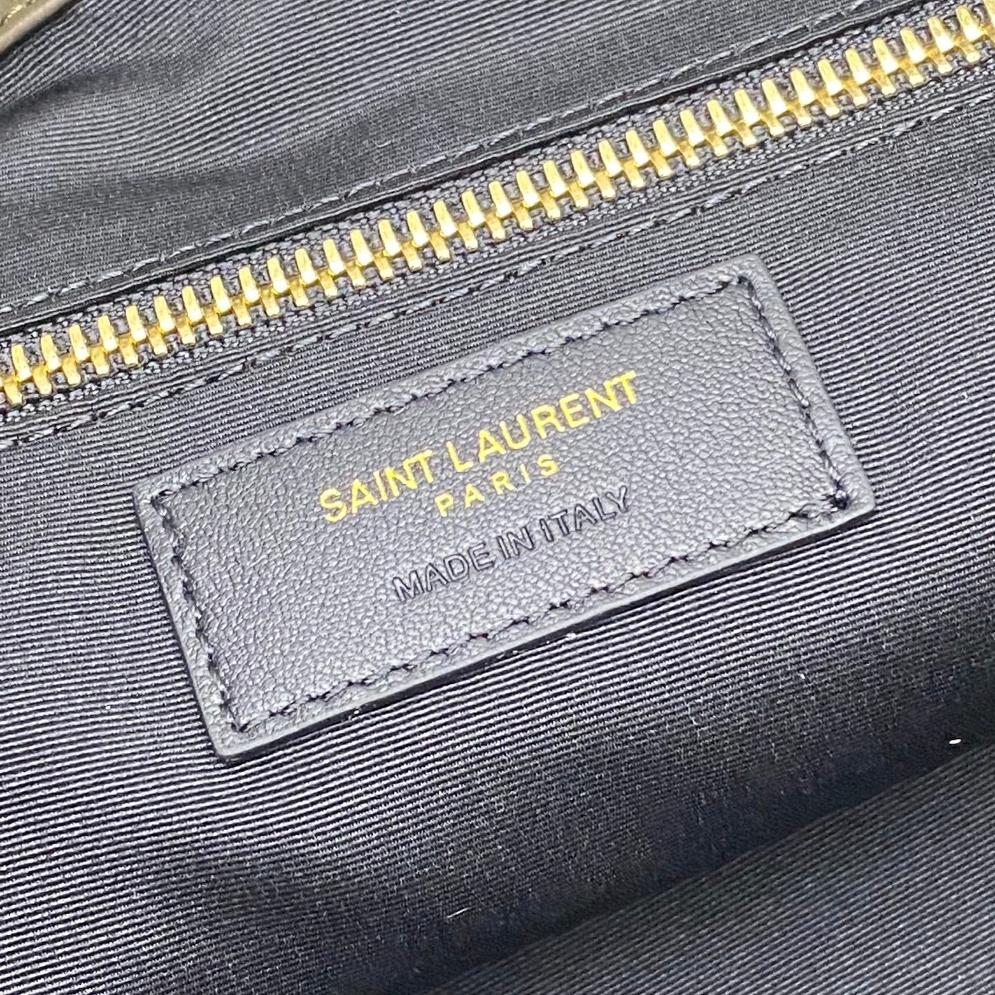 Saint Laurent Paris leather label with Made in Italy on dark green tote bag