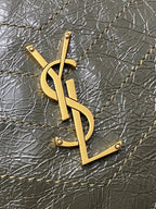 Gold YSL monogram pendant on dark green textured leather