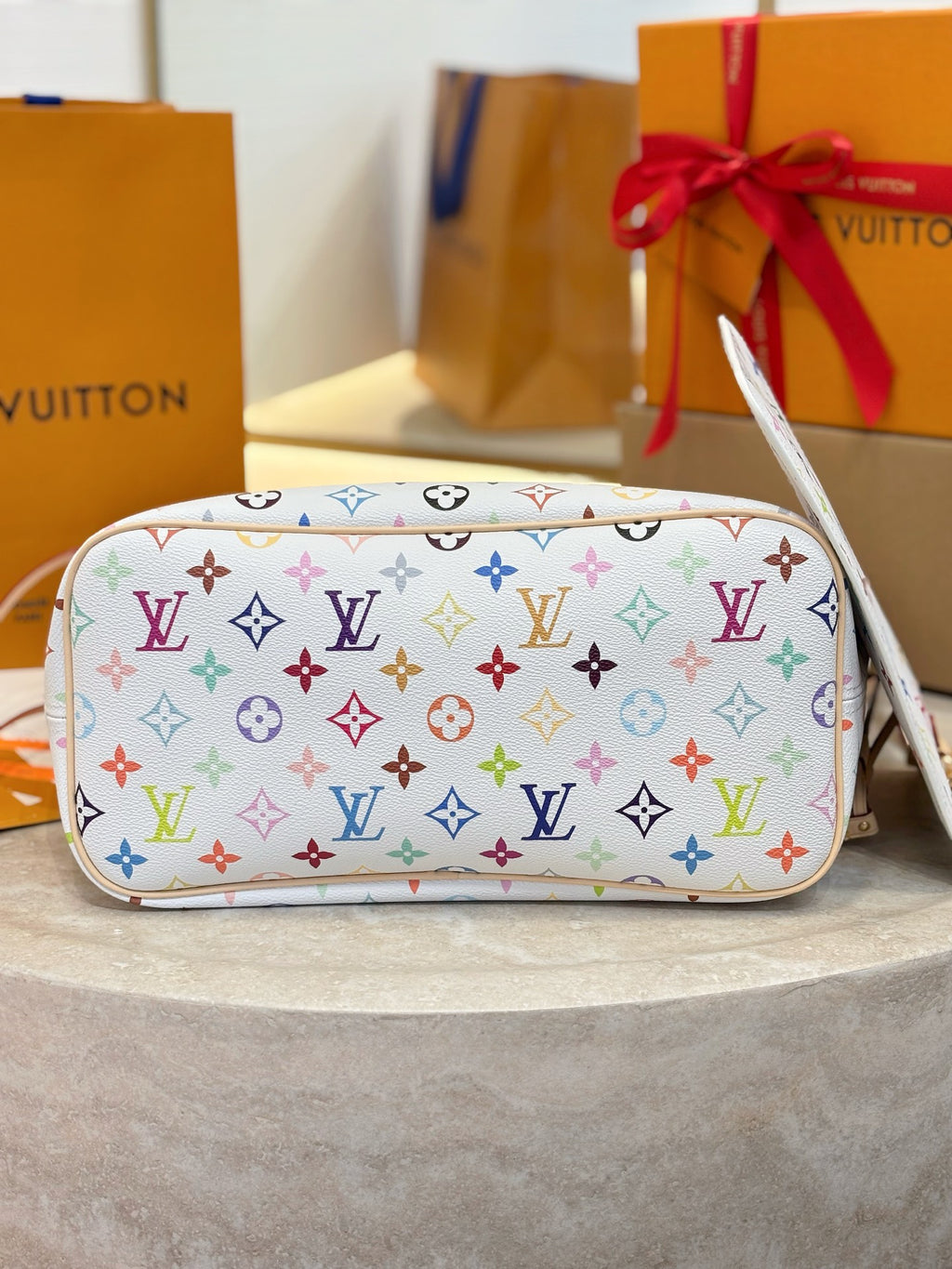 Louis Vuitton monogram crossbody-style pouch with multicolor logo pattern and top zipper