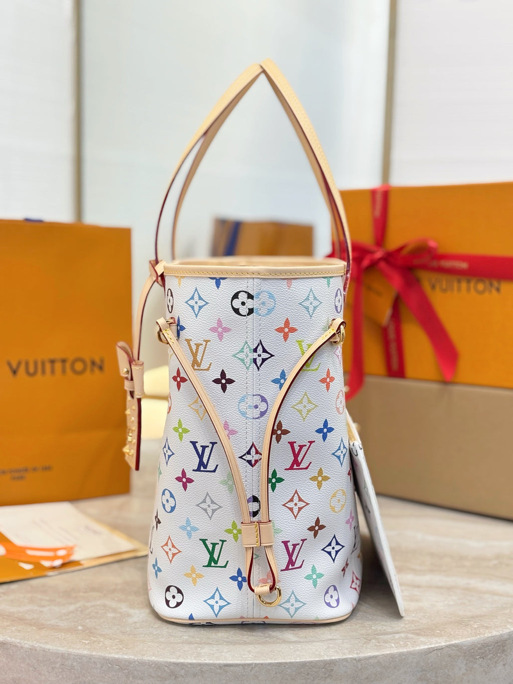 Louis Vuitton small structured bag with multicolor monogram print, tan top handle, side pocket