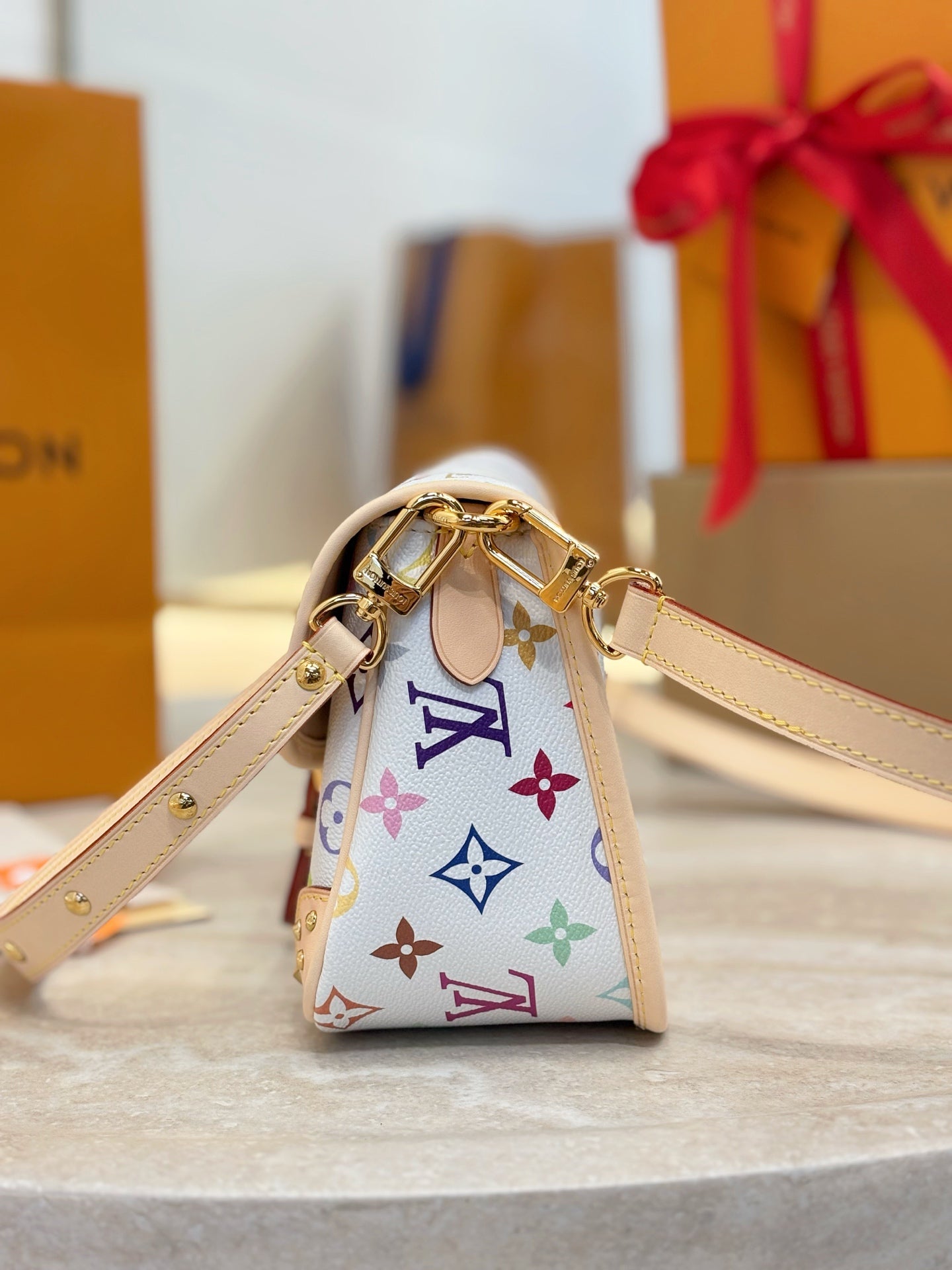 Louis Vuitton crossbody bag top view with gold-tone D-ring hardware and multicolor monogram print