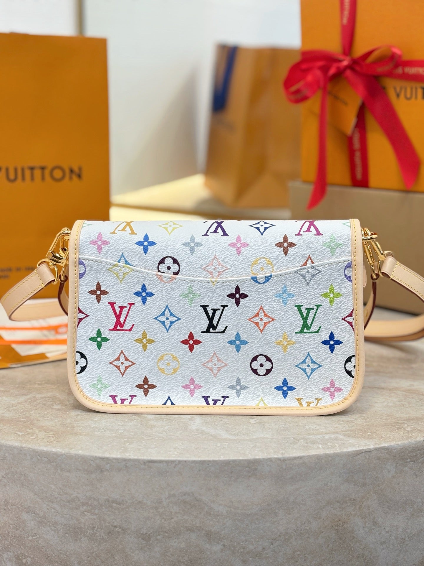 Louis Vuitton crossbody bag with multicolor monogram print and top zipper closure