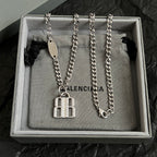 Two silver-tone chain necklaces with square charm pendants and oval tags