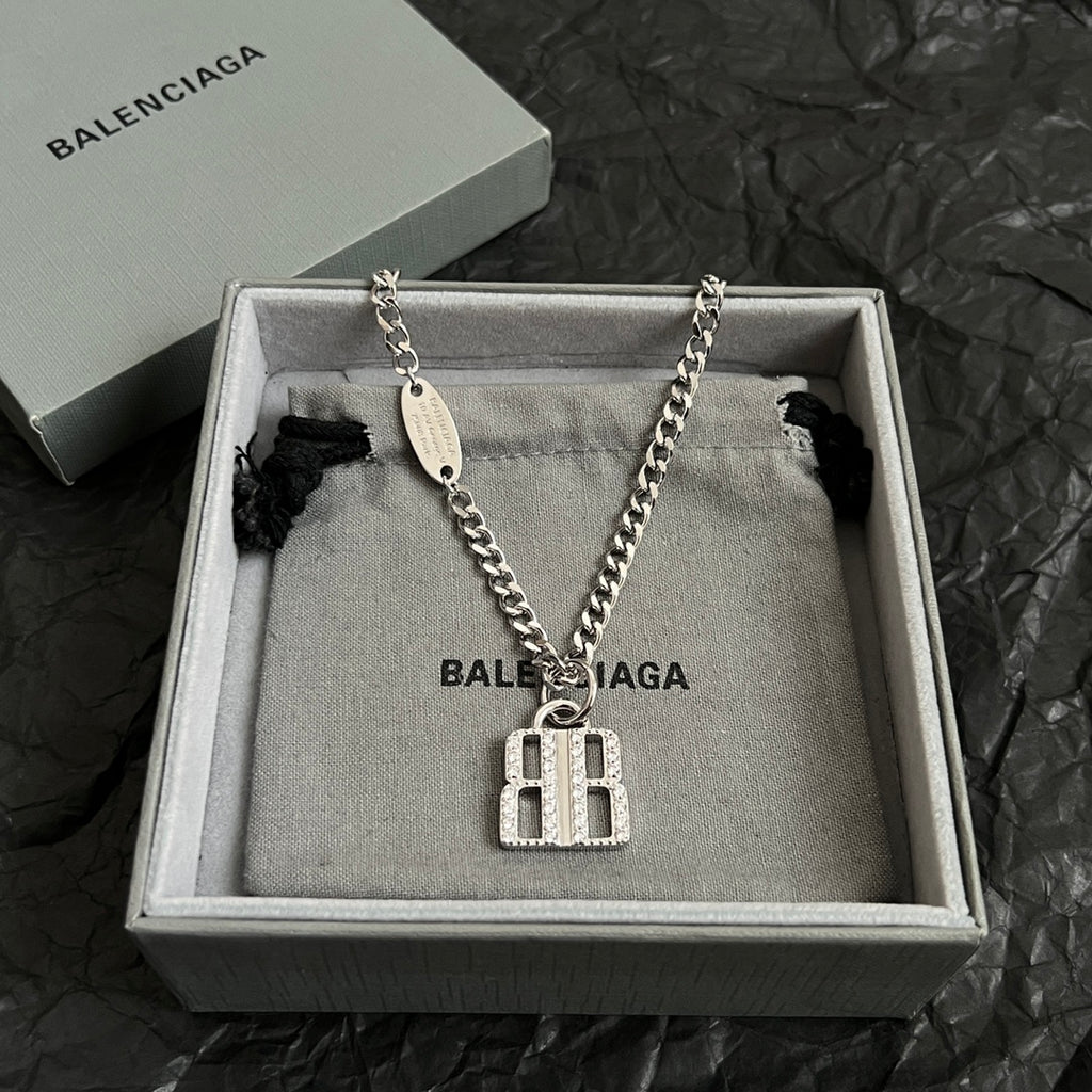 Silver-tone chain necklace with oval tag and square charm pendant