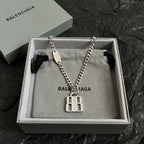 Silver-tone chain necklace with oval tag and square charm pendant