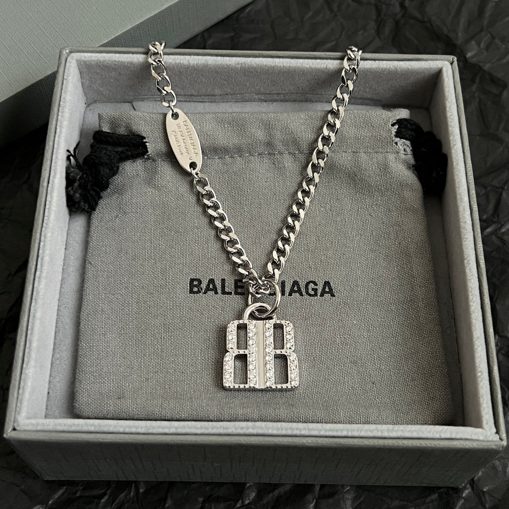 Silver-tone chain necklace with oval tag and square charm pendant