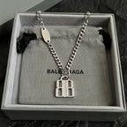Silver-tone chain necklace with oval tag and square charm pendant