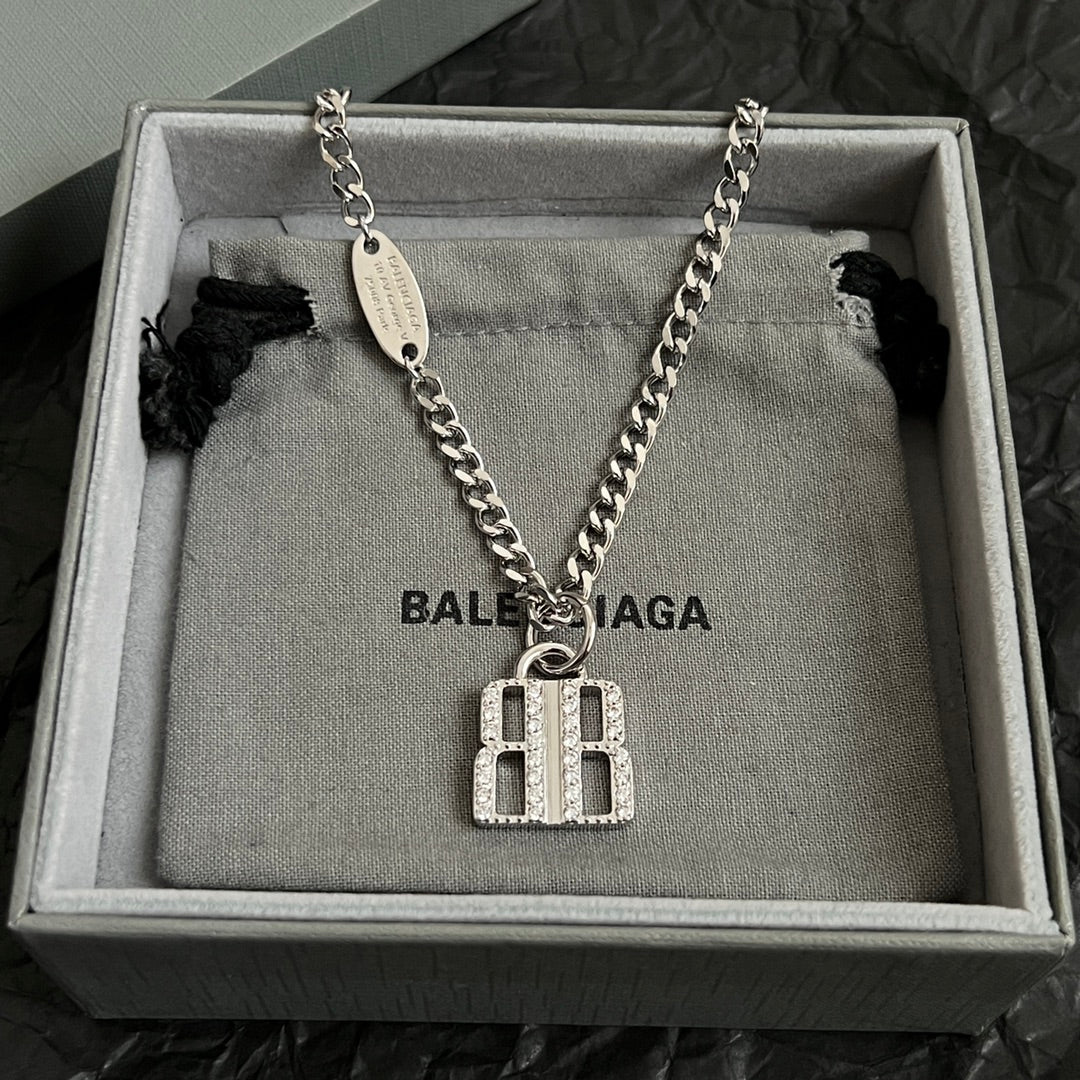 Silver-tone chain necklace with oval tag and square charm pendant