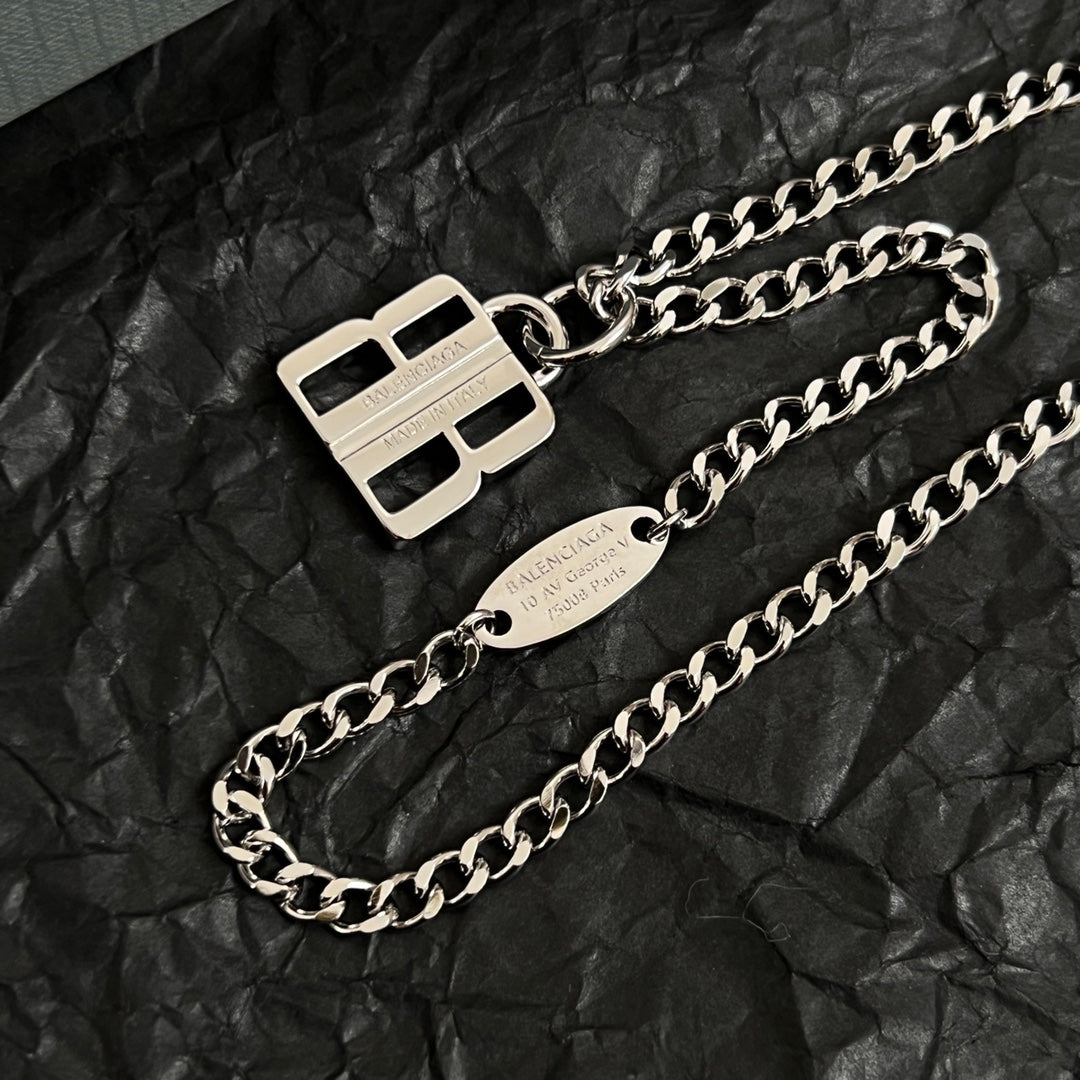 Silver-tone chain necklace with square logo charm and oval name tag