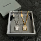 Balenciaga accessory necklace set with silver and gold B logo pendants