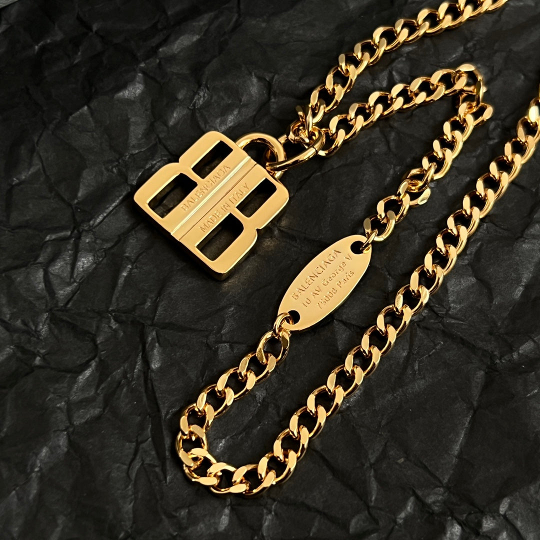 Balenciaga accessory gold B logo pendant on chain with engraved tag