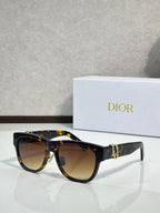 Dior sunglasses with dark tortoiseshell frames and brown-tinted lenses, gold logo detail