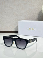 Dior sunglasses with black frames and dark lenses, silver-toned logo detail on the temple