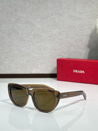 Prada sunglasses with tortoiseshell frames and dark tinted lenses, angled side view