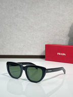 Prada sunglasses with black frames and green-tinted lenses, angled side view