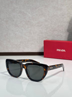 Prada sunglasses with tortoiseshell frames and dark tinted lenses, front view