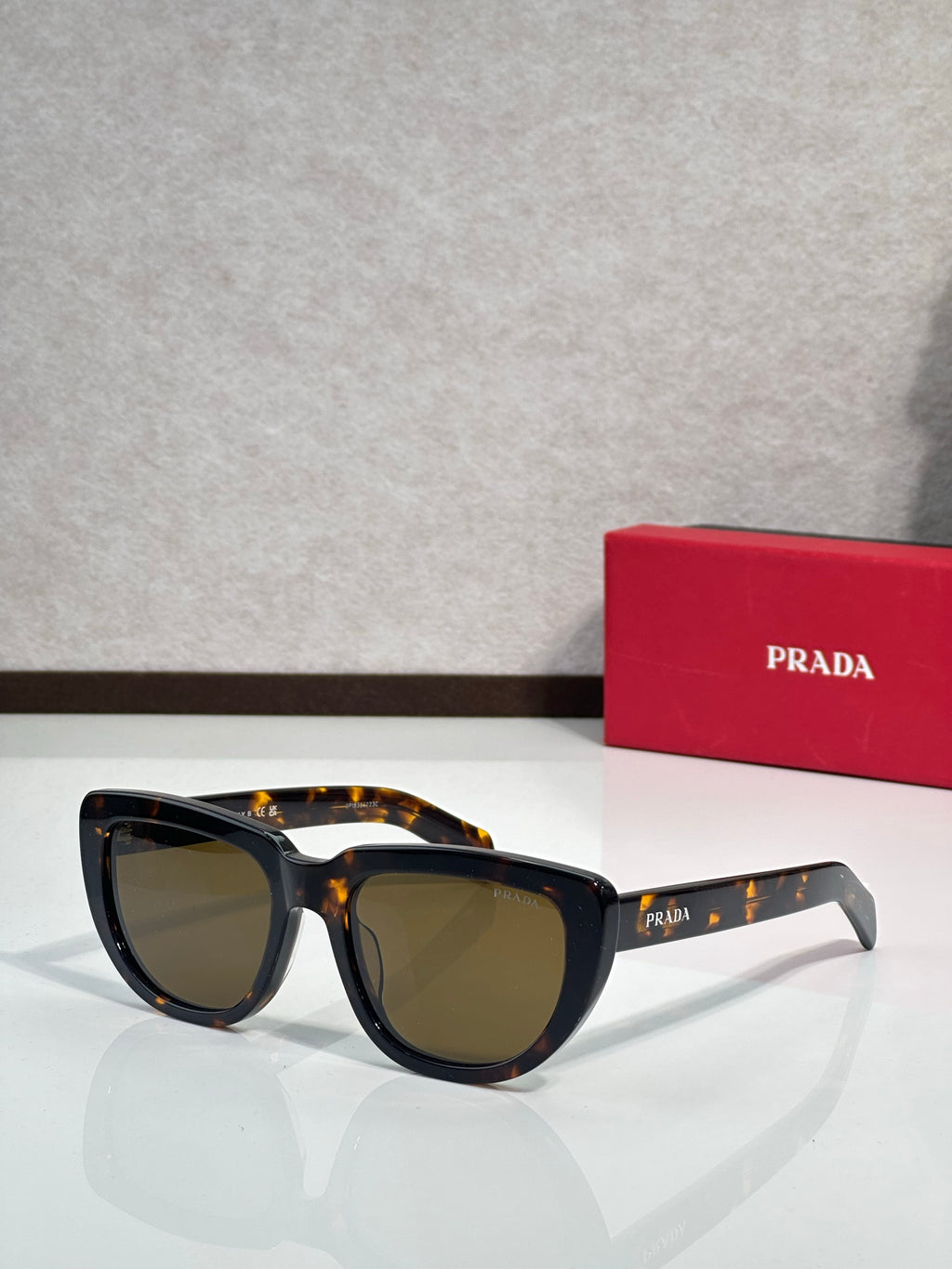 Prada sunglasses with black and tortoiseshell frames, dark tinted lenses