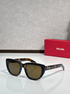 Prada sunglasses with black and tortoiseshell frames, dark tinted lenses