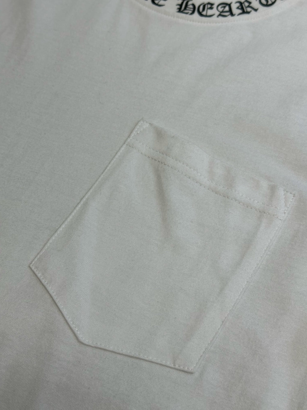 White T-shirt chest pocket detail with clean topstitching
