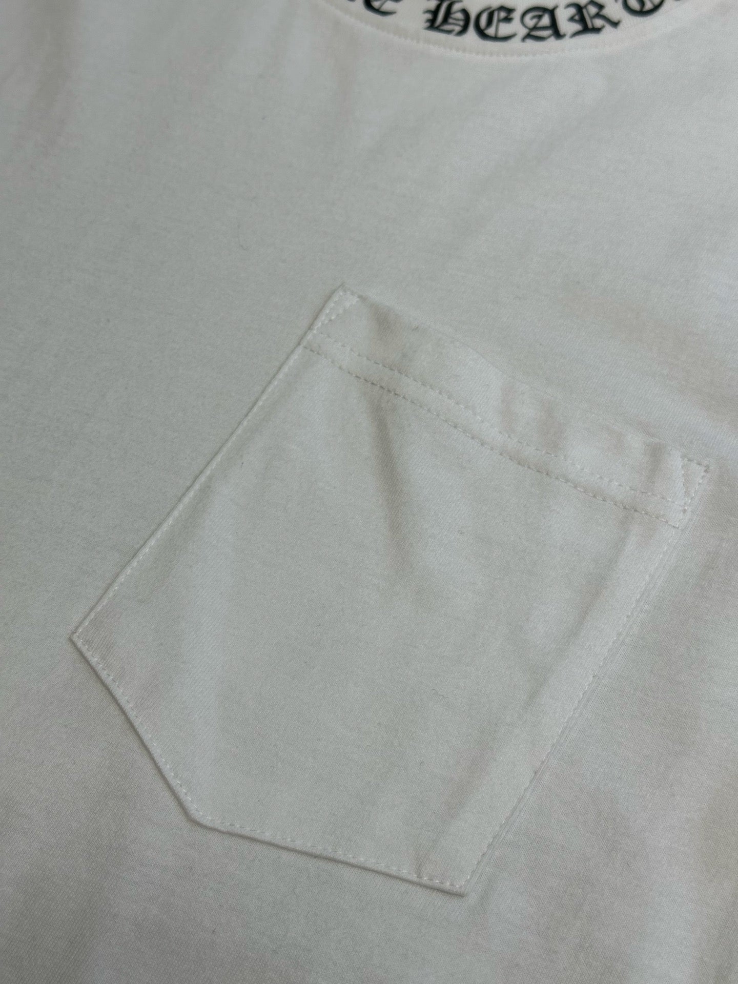 White T-shirt chest pocket detail with clean topstitching