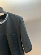 Black short-sleeve T-shirt with chest pocket and visible side seam stitching