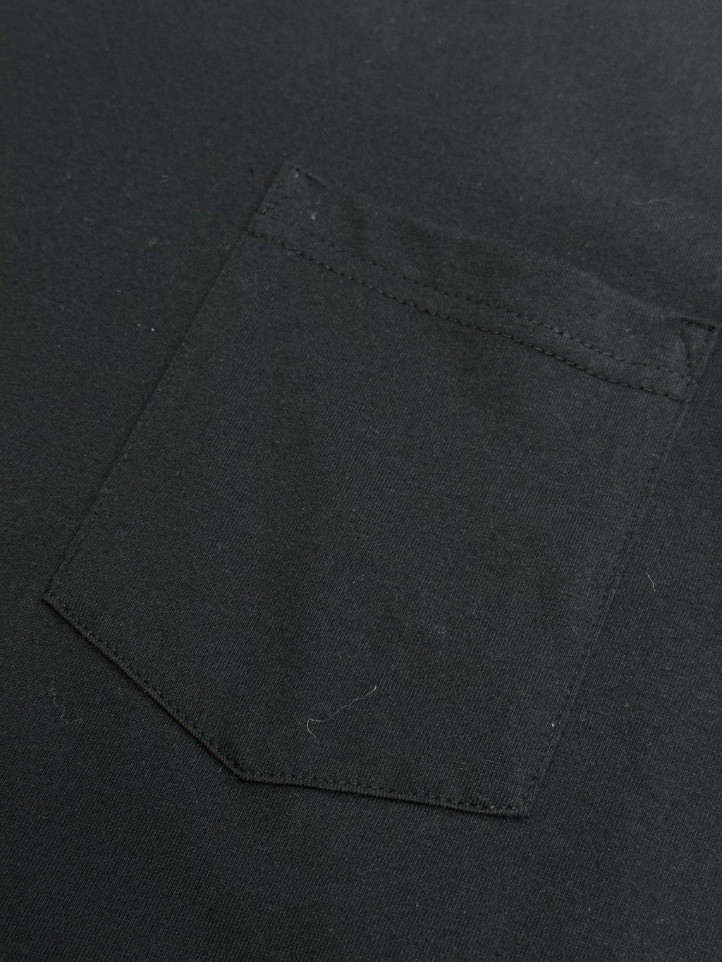 Black T-shirt with square chest pocket and visible topstitching
