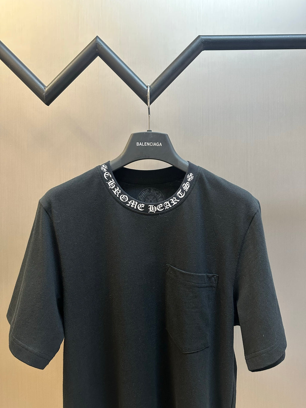 Black short-sleeve crewneck T-shirt with embroidered neck graphic and chest pocket