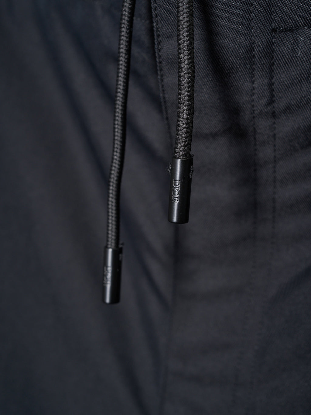 Drawstring ends on dark pants waistband