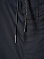 Drawstring ends on dark pants waistband