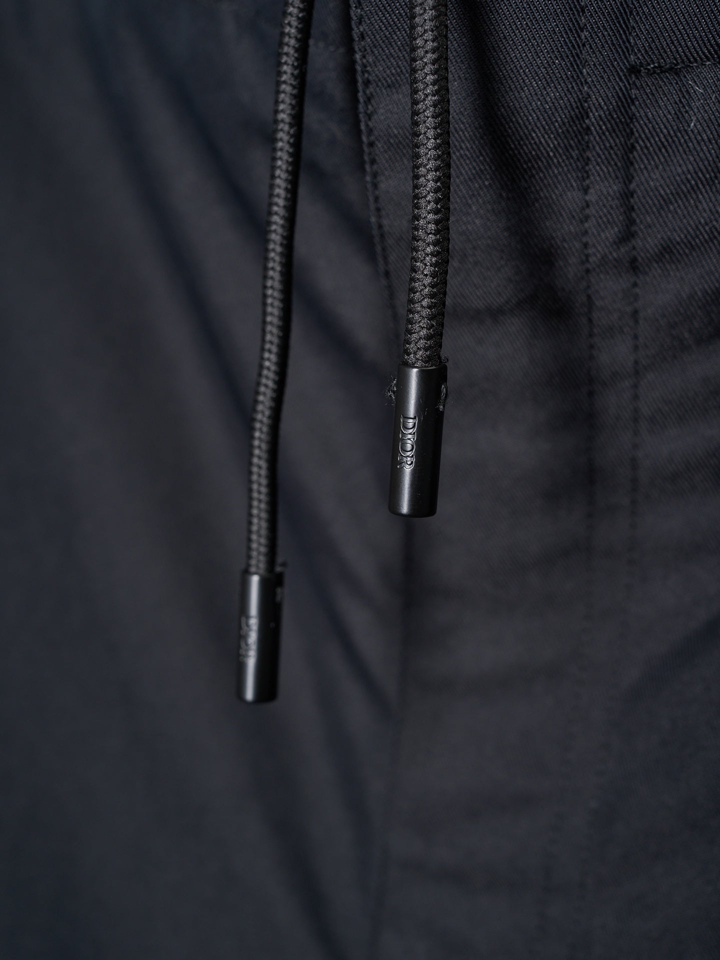 Drawstring ends on dark pants waistband