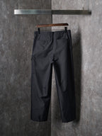 Dark tapered drawstring pants with front slash pockets and belt loops